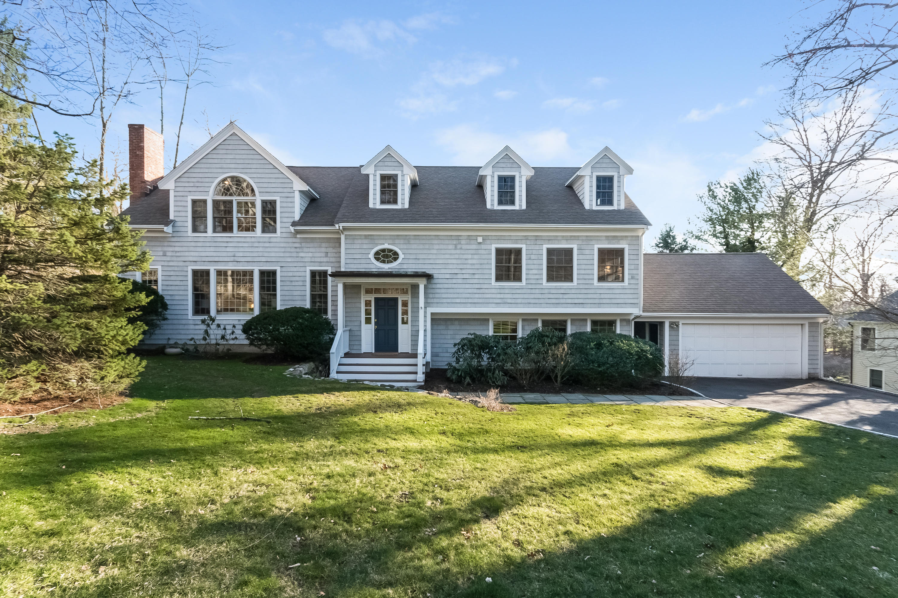26 Stanton Road Darien, CT 06820 - Photo 3 of 40 a front view of a house with a yard and garage