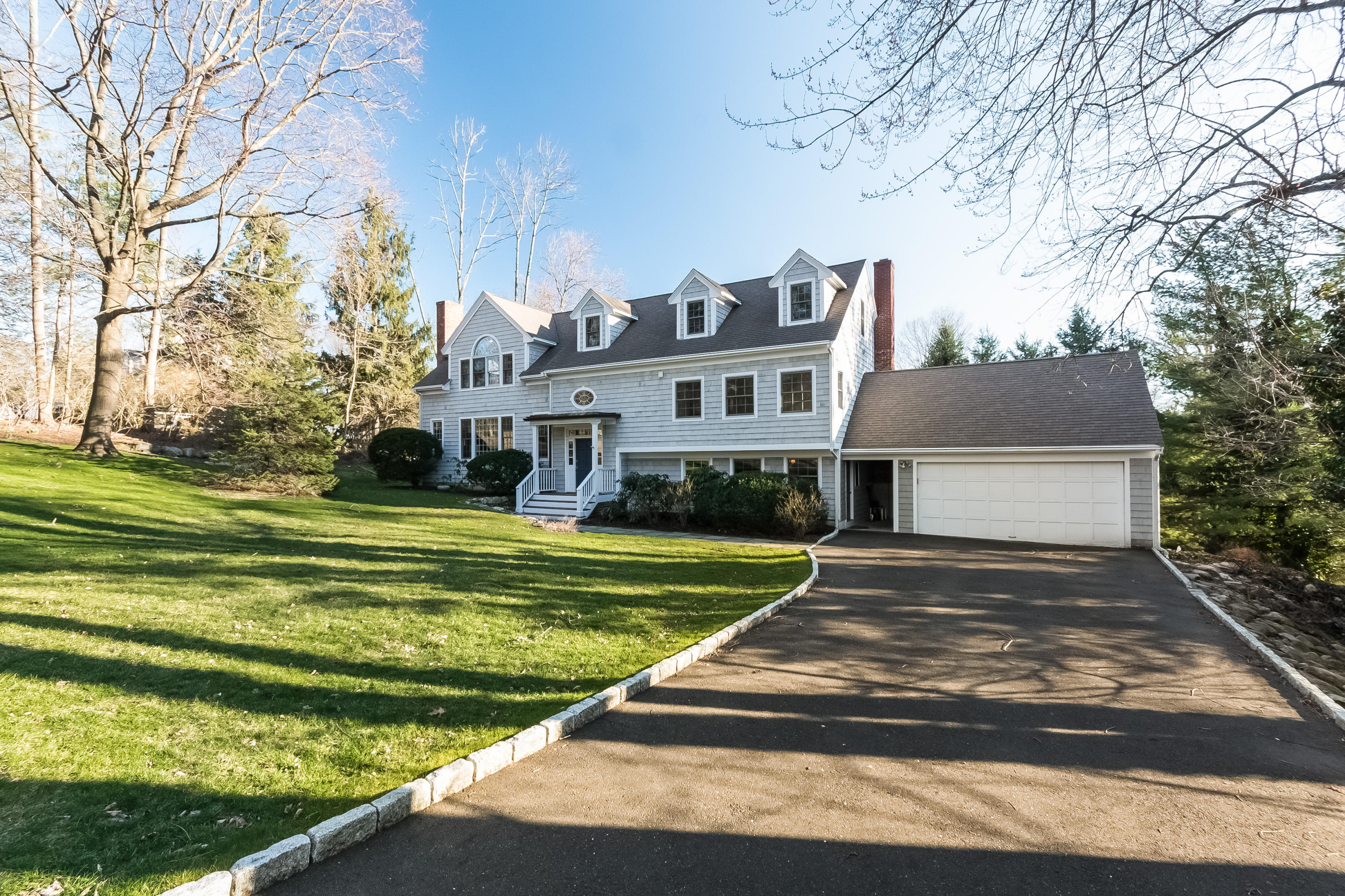 26 Stanton Road Darien, CT 06820 - Photo 4 of 40 a front view of house with yard and trees in the background