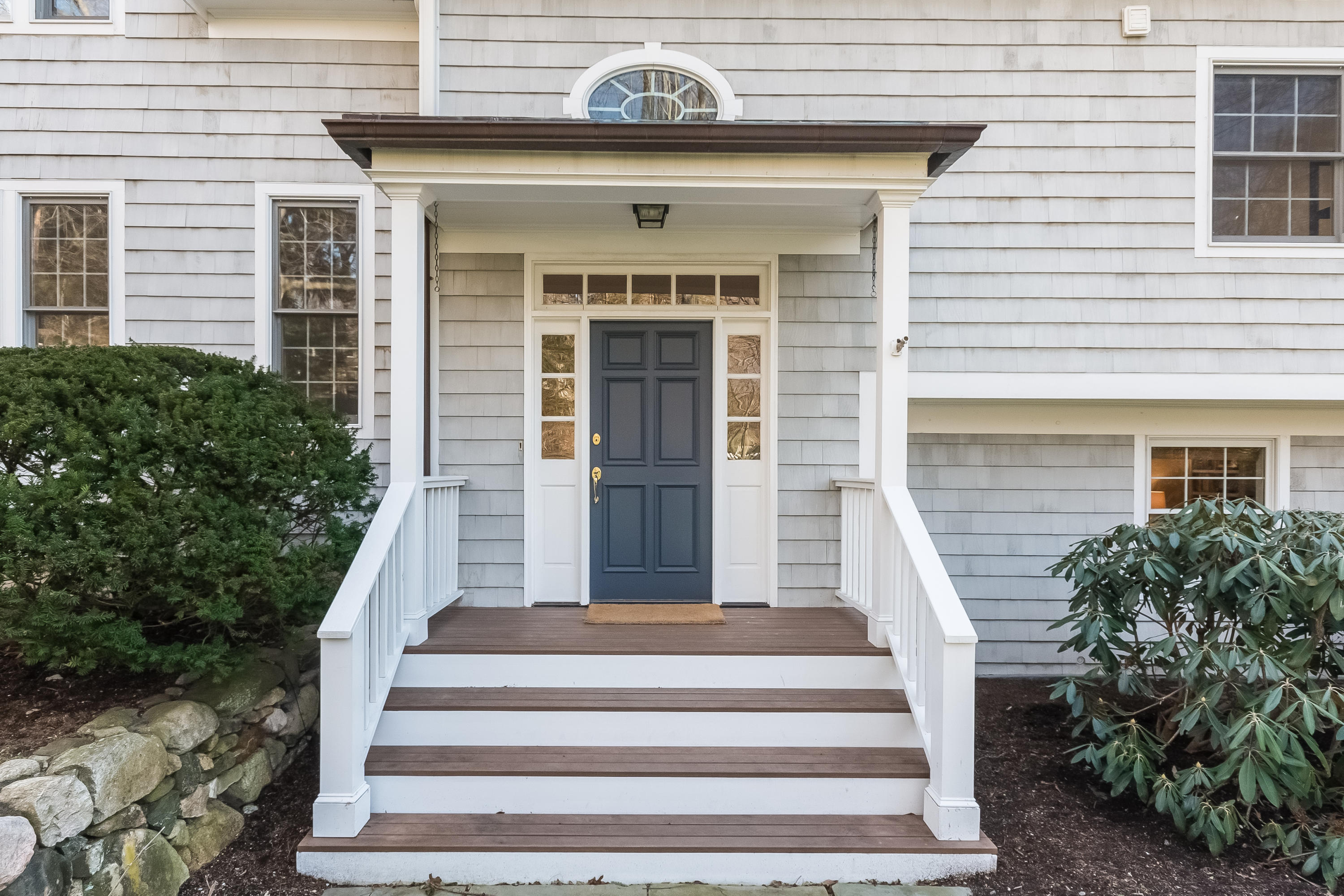 26 Stanton Road Darien, CT 06820 - Photo 5 of 40 a front view of a house with potted plants