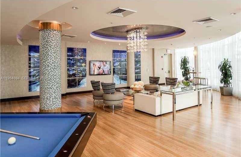 244 Biscayne Boulevard, Unit 1605 Miami, FL 33132 - Photo 46 of 48 a living room with furniture and a chandelier