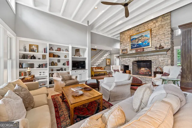 a kitchen with granite countertop white cabinets and wooden floor