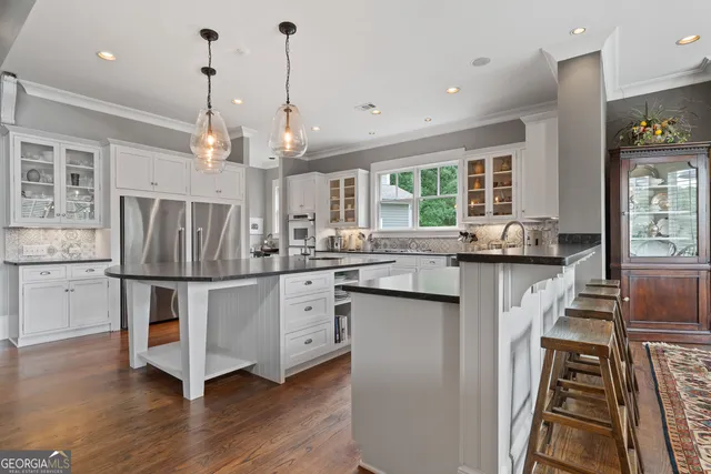 a view of a patio with lawn chairs and a large tree