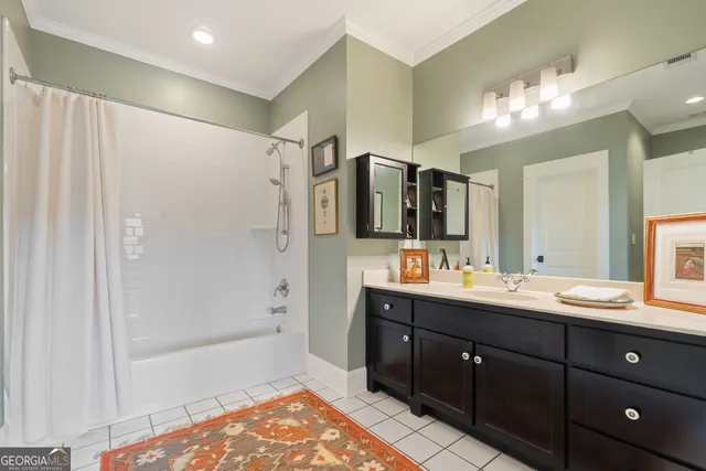 a bathroom with a toilet sink double vanity and mirror