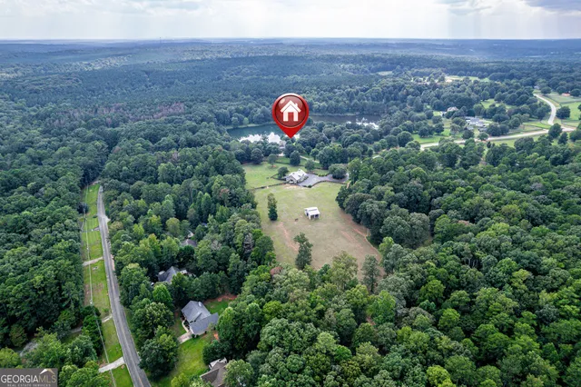 a front view of a house with a yard and trees