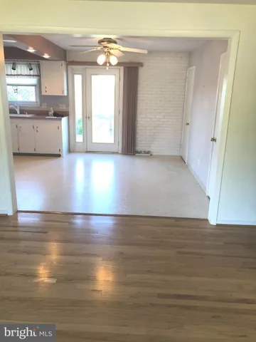 a view of a kitchen with an empty space and a window