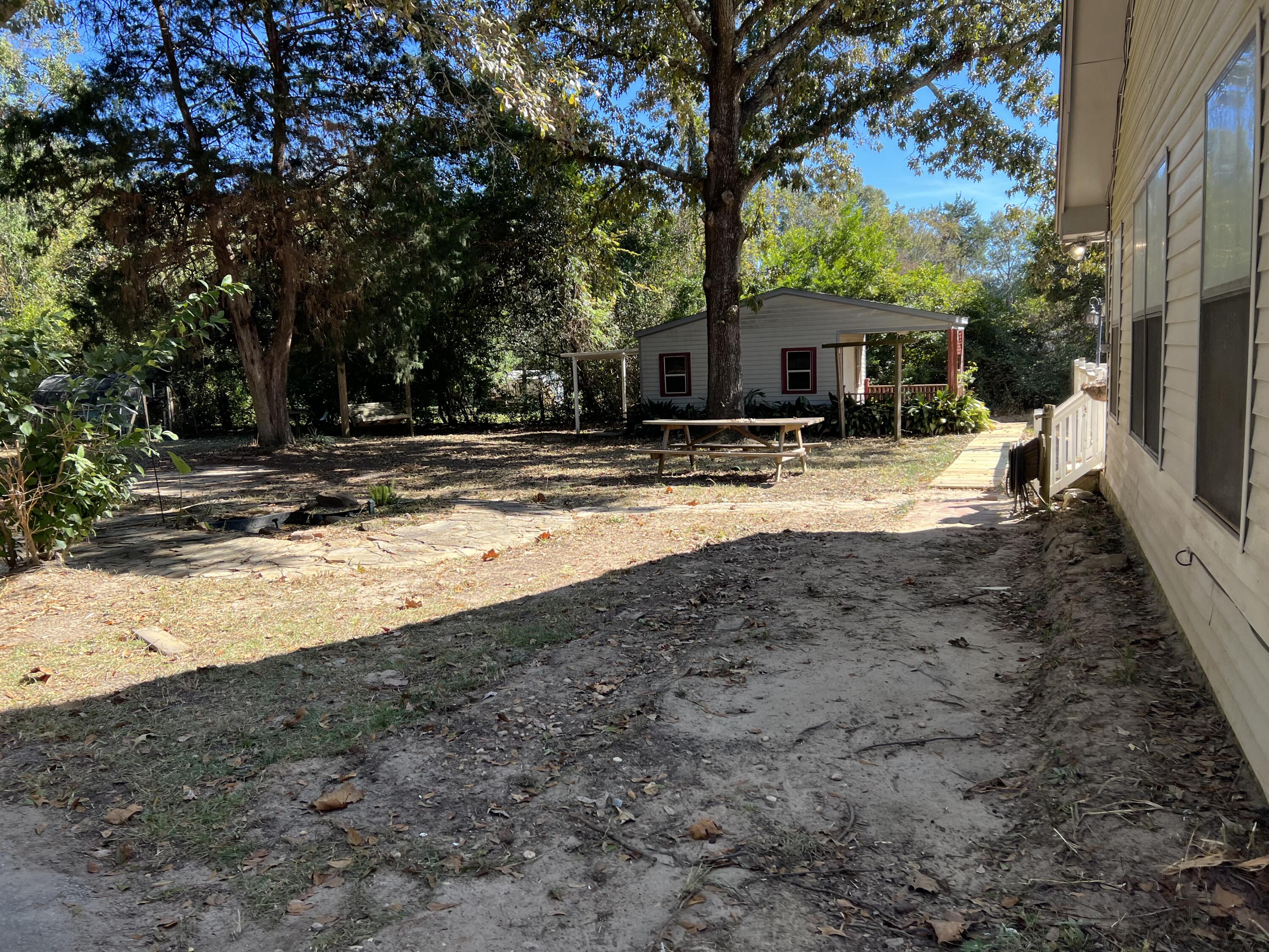 6028 Old Bethel Road Crestview, FL 32536 - Photo 11 of 16 a view of a house with backyard and a tree