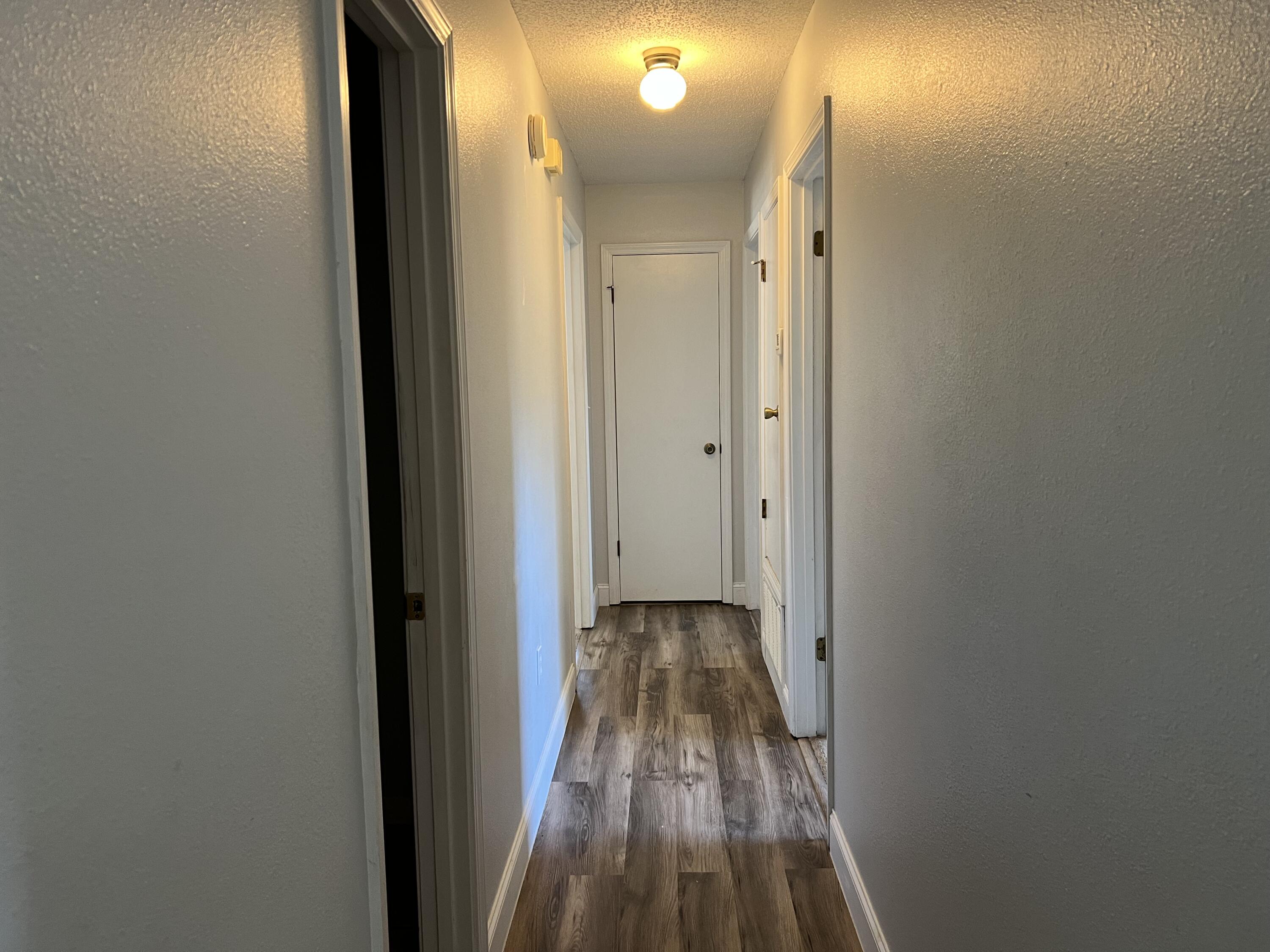 6028 Old Bethel Road Crestview, FL 32536 - Photo 4 of 16 a view of a hallway with wooden floor