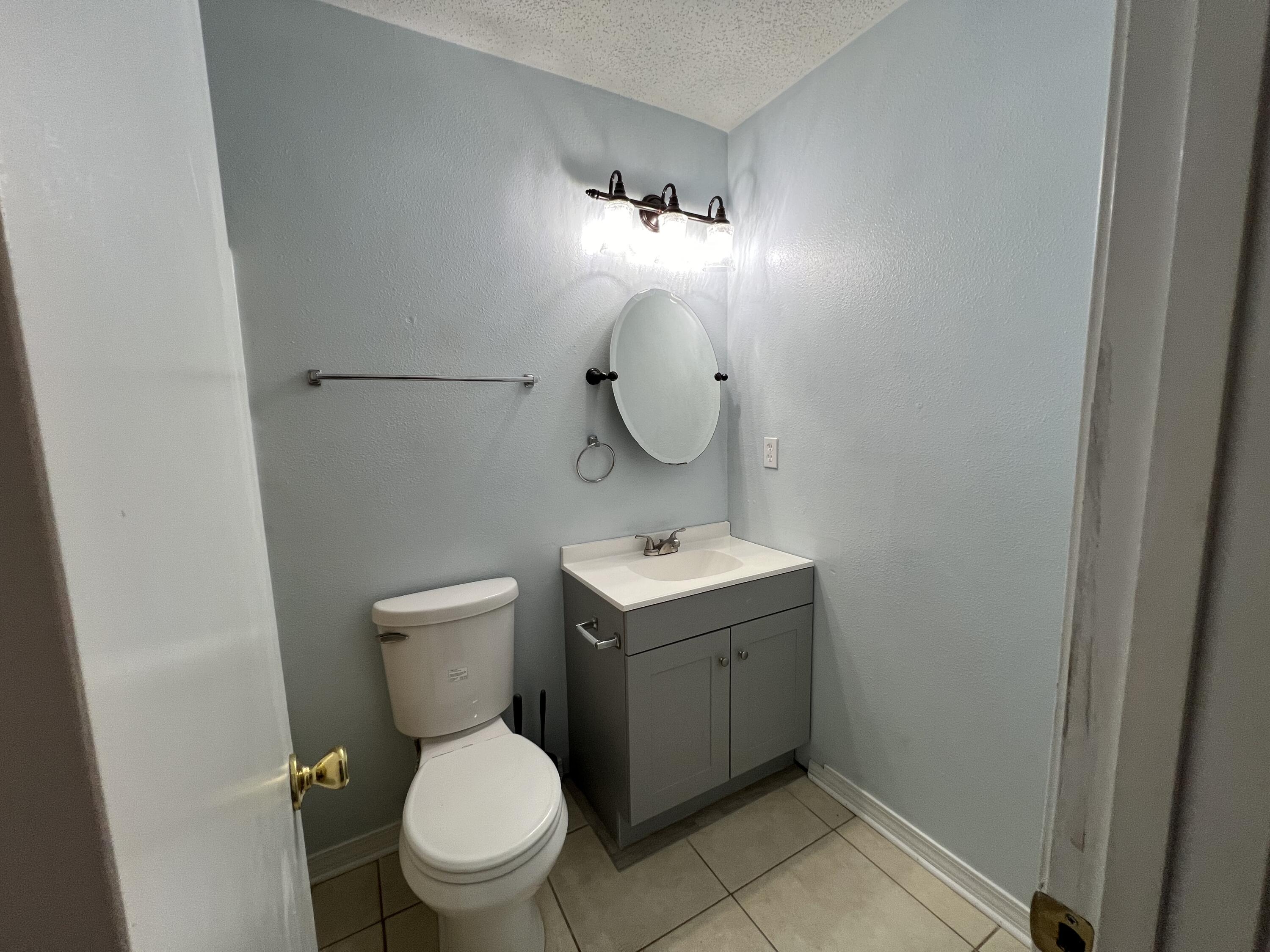6028 Old Bethel Road Crestview, FL 32536 - Photo 5 of 16 a bathroom with a toilet sink and mirror