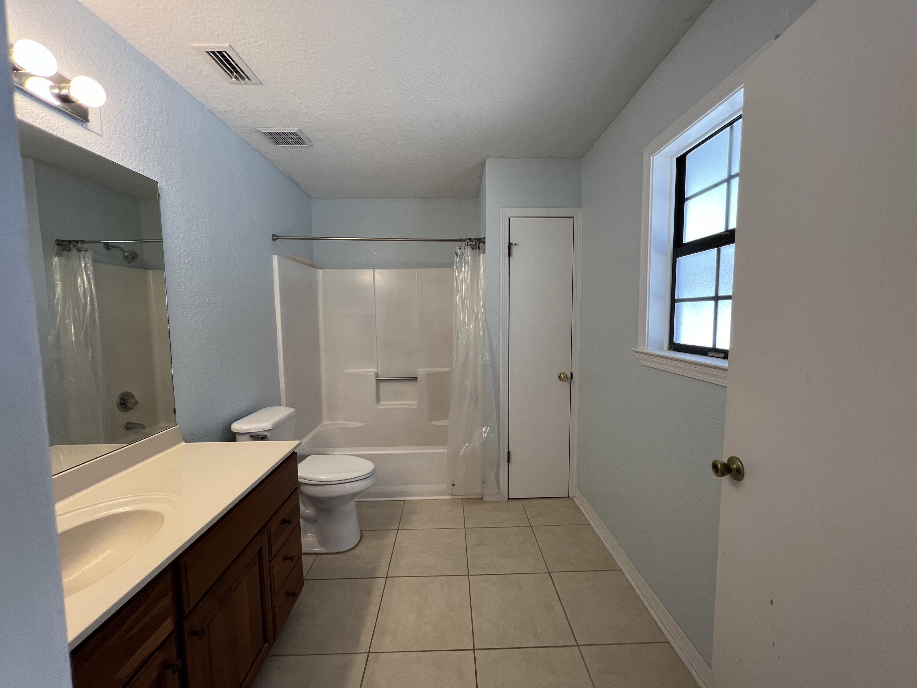 6028 Old Bethel Road Crestview, FL 32536 - Photo 8 of 16 a bathroom with a double vanity sink toilet and shower