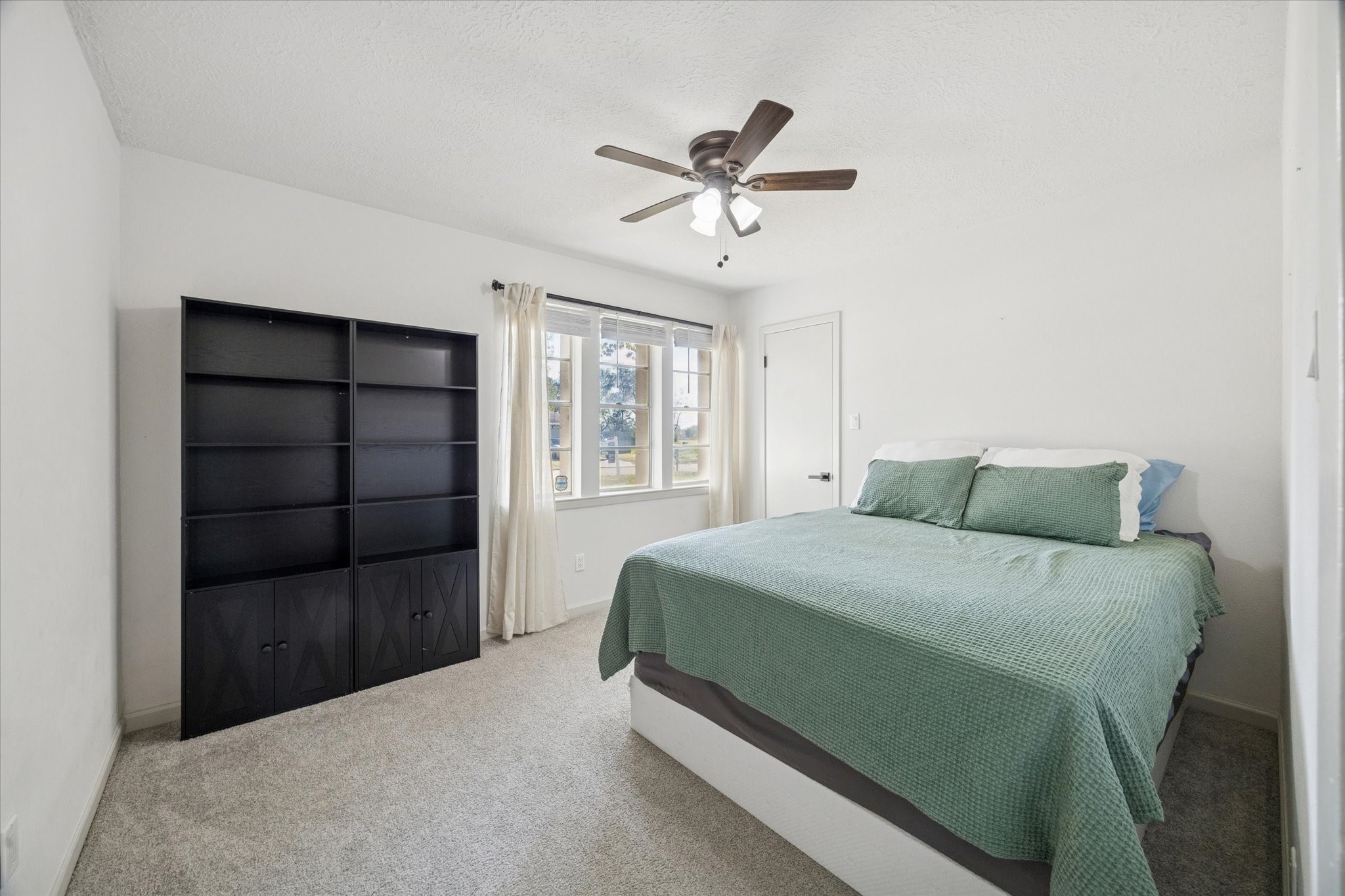 11207 Rousseau Drive Houston, TX 77065 - Photo 11 of 20 a bedroom with a bed and a window