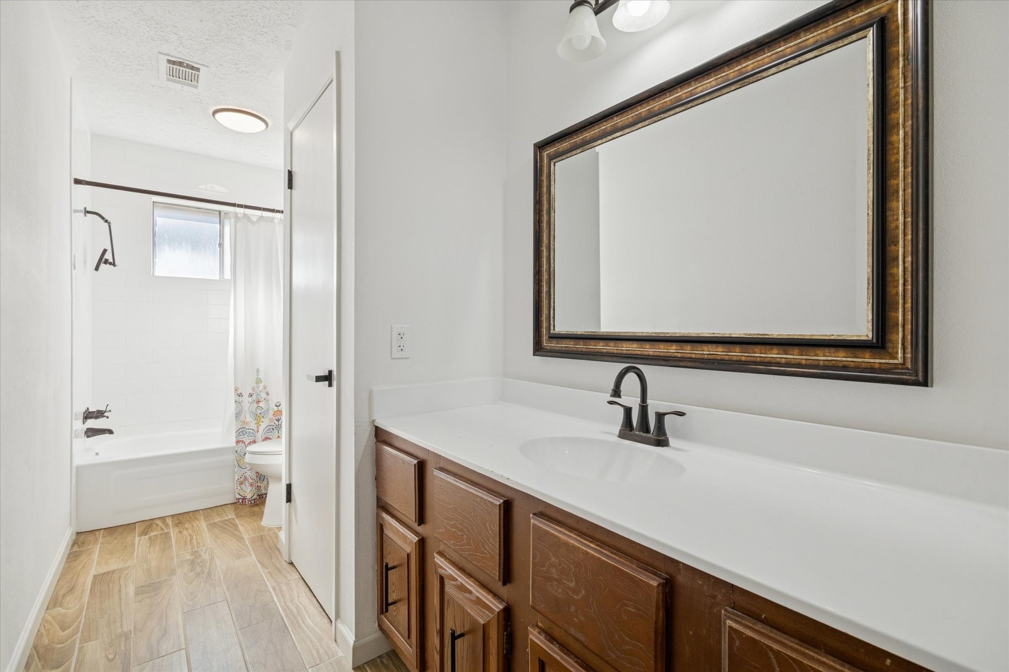 11207 Rousseau Drive Houston, TX 77065 - Photo 12 of 20 a bathroom with a sink and a mirror