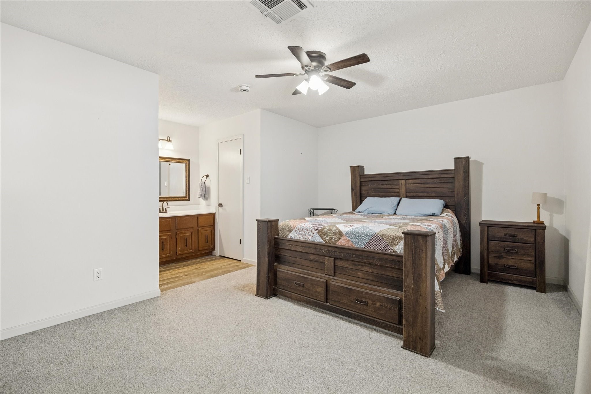 11207 Rousseau Drive Houston, TX 77065 - Photo 13 of 20 a bedroom with a bed and a chandelier