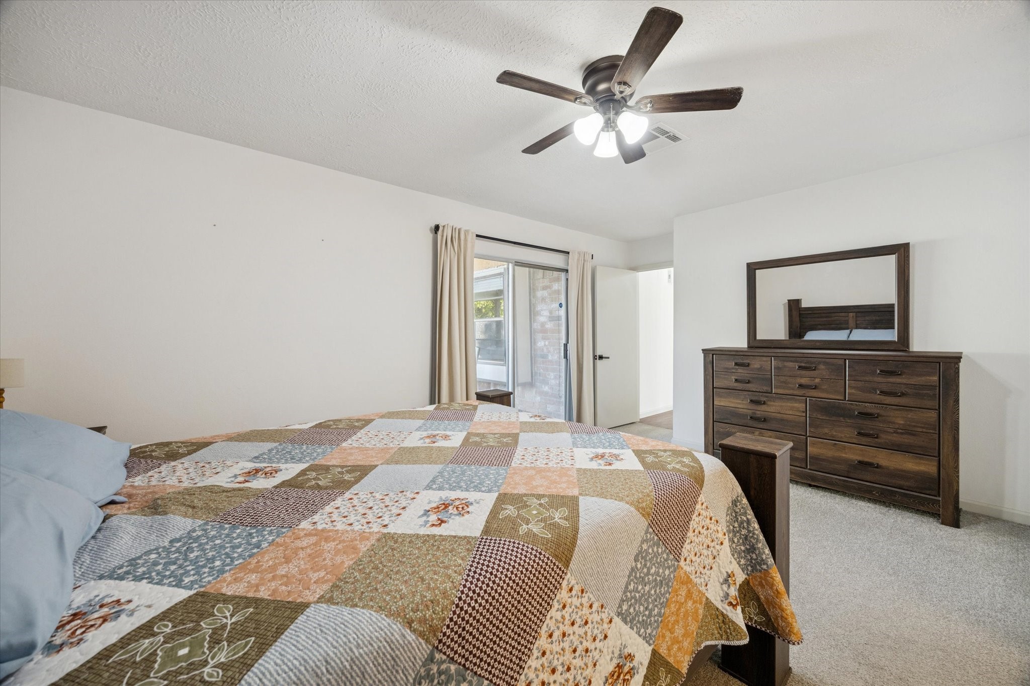 11207 Rousseau Drive Houston, TX 77065 - Photo 14 of 20 a bedroom with a bed a chandelier and a flat screen tv