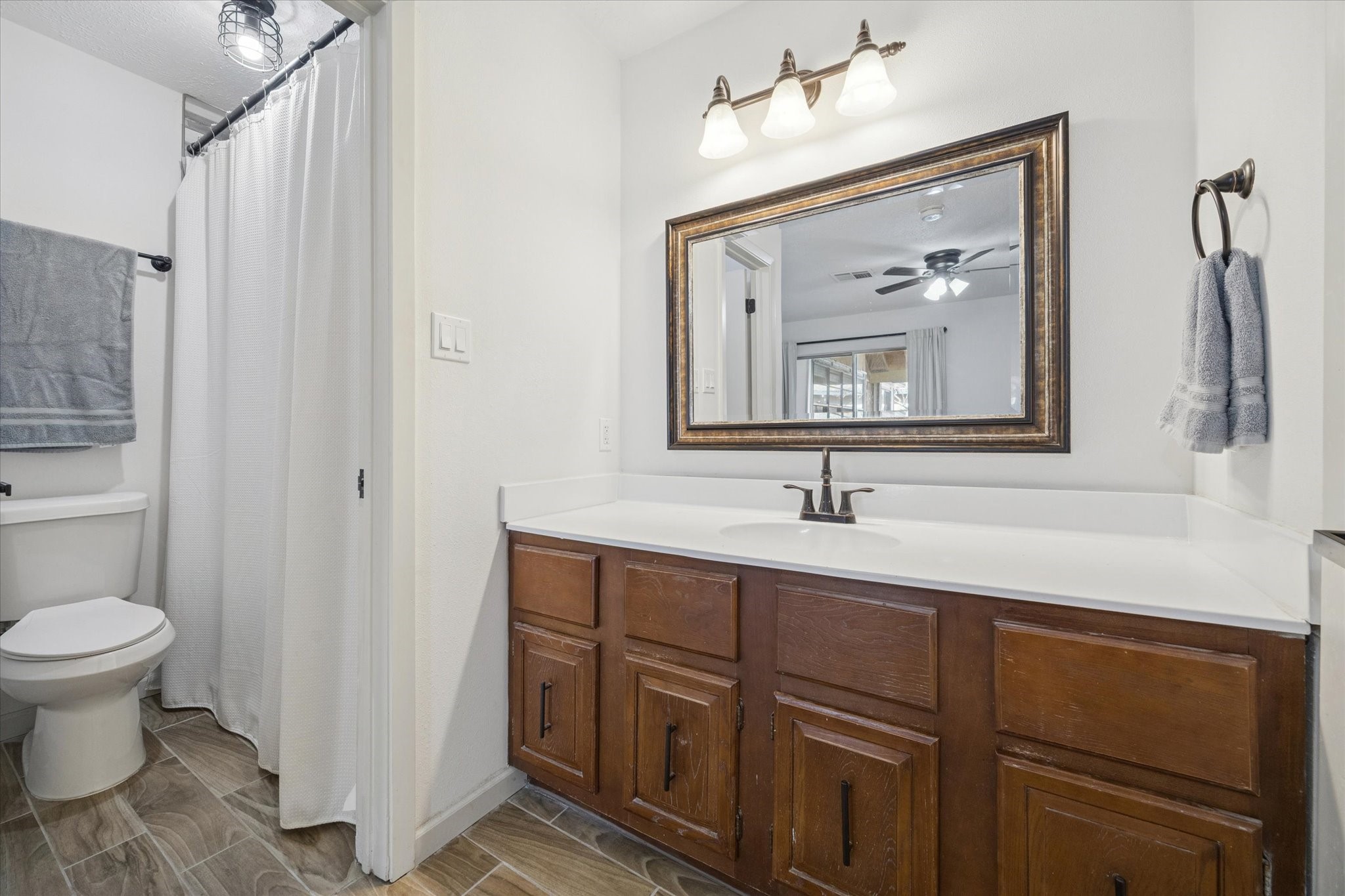 11207 Rousseau Drive Houston, TX 77065 - Photo 15 of 20 a bathroom with a toilet sink and mirror