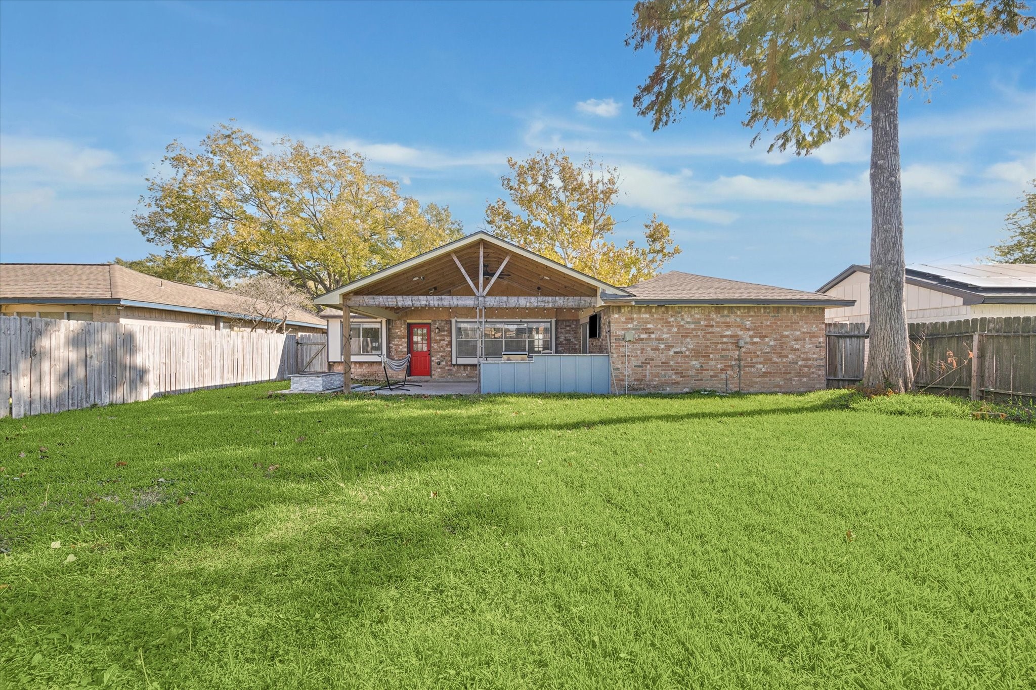 11207 Rousseau Drive Houston, TX 77065 - Photo 17 of 20 a view of a house with a big yard potted plants and large tree