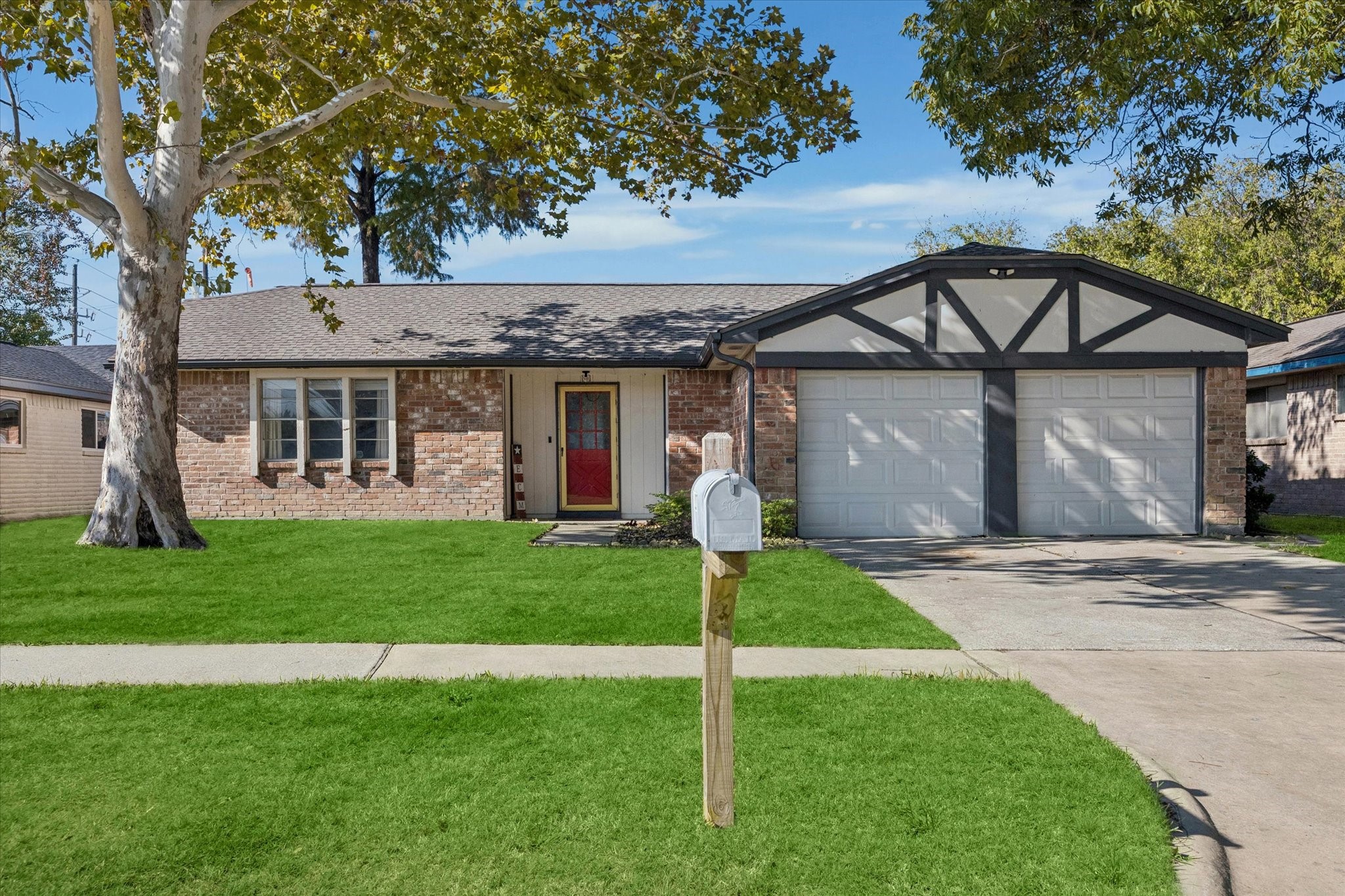 11207 Rousseau Drive Houston, TX 77065 - Photo 2 of 20 a front view of a house with a garden and yard