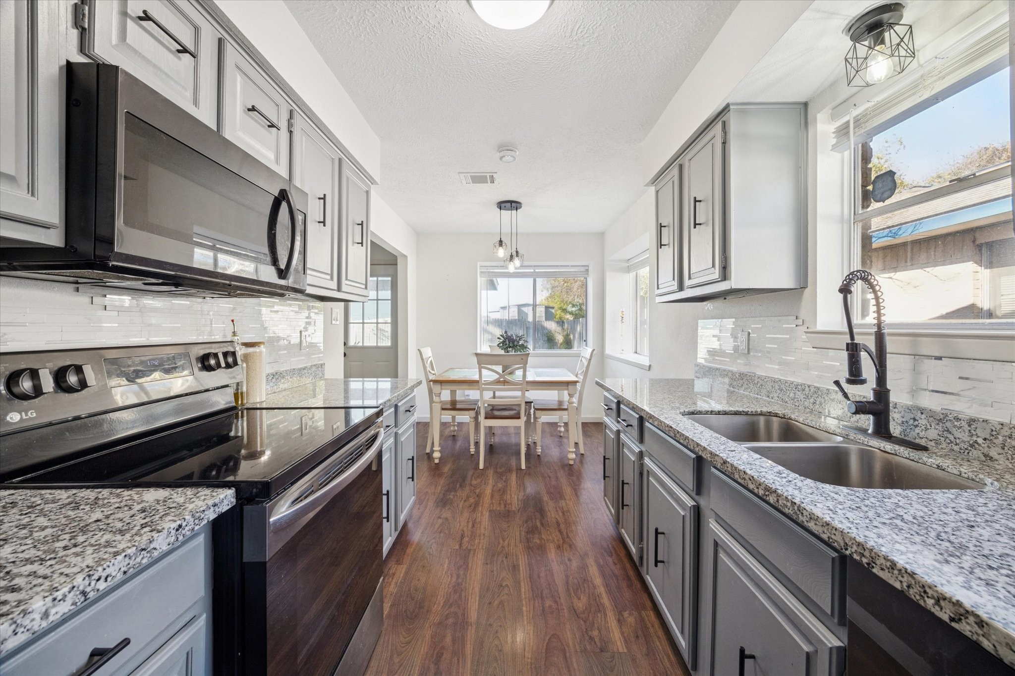 11207 Rousseau Drive Houston, TX 77065 - Photo 10 of 20 a kitchen with a stove sink and cabinets