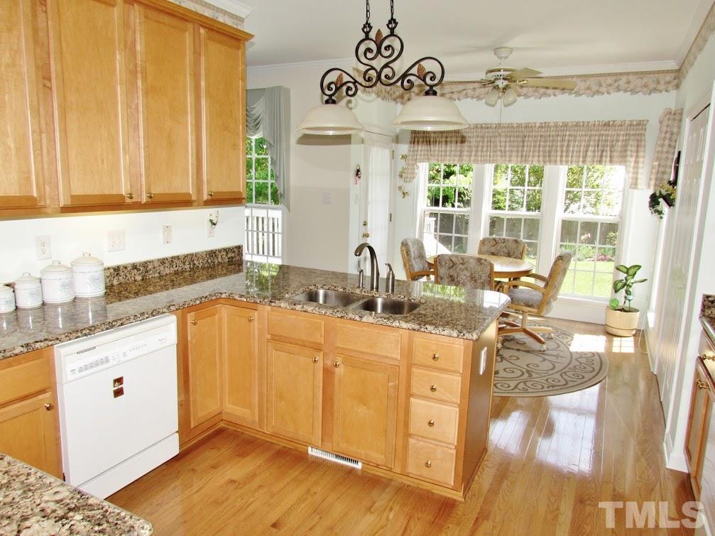 4720 Treadstone Court Raleigh, NC 27616 - Photo 7 of 25 A kitchen that any chef would love! Special features include: 42" maple cabinets, under cabinet lighting, large pantry, lots of counter space for prep area, hardwood floors, lots of cabinet space and granite counter tops.