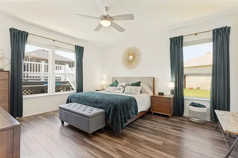 a spacious bedroom with a bed and a large window
