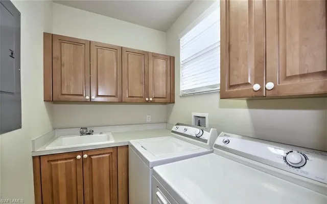 a utility room with sink dryer and washer
