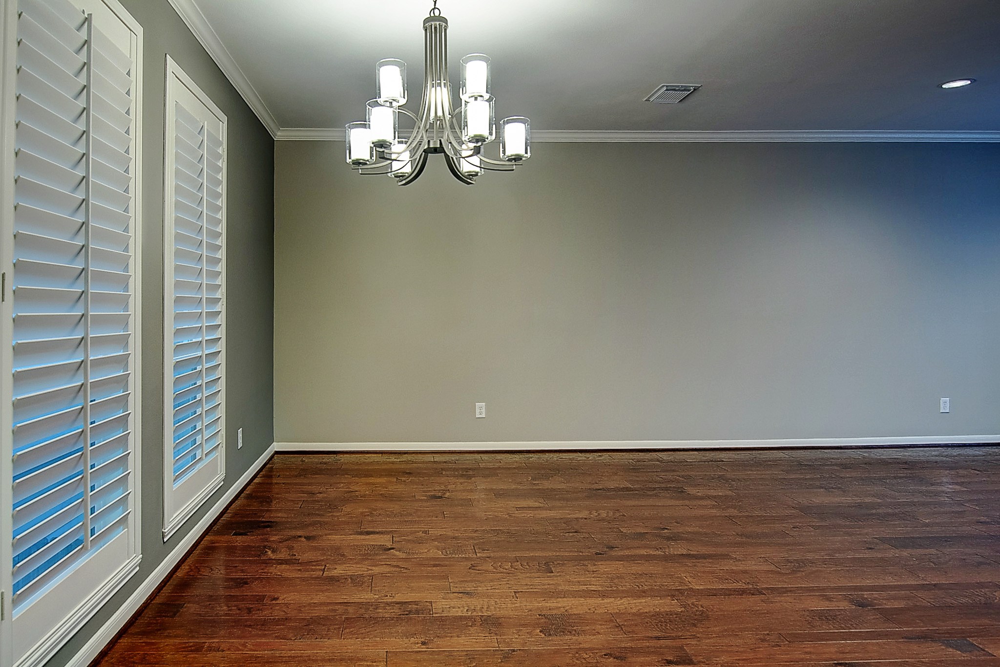 1408 West Webster Street Houston, TX 77019 - Photo 14 of 46 a view of a room with wooden floor and chandelier