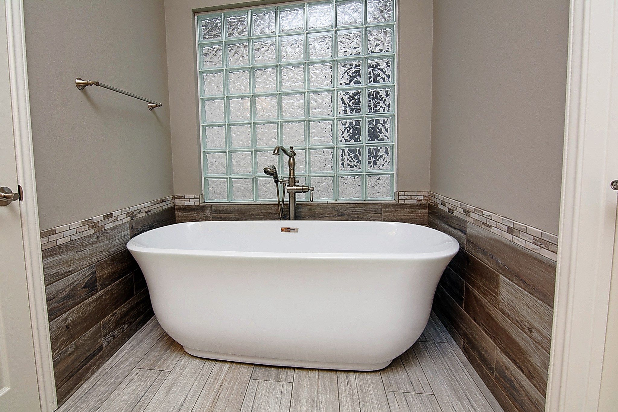 1408 West Webster Street Houston, TX 77019 - Photo 23 of 46 a white bath tub sitting in a bathroom next to a window