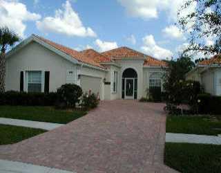 1410 Southwest Balmoral Trace Stuart, FL 34997 - Photo 1 of 1 a view of a house with a yard and potted plants