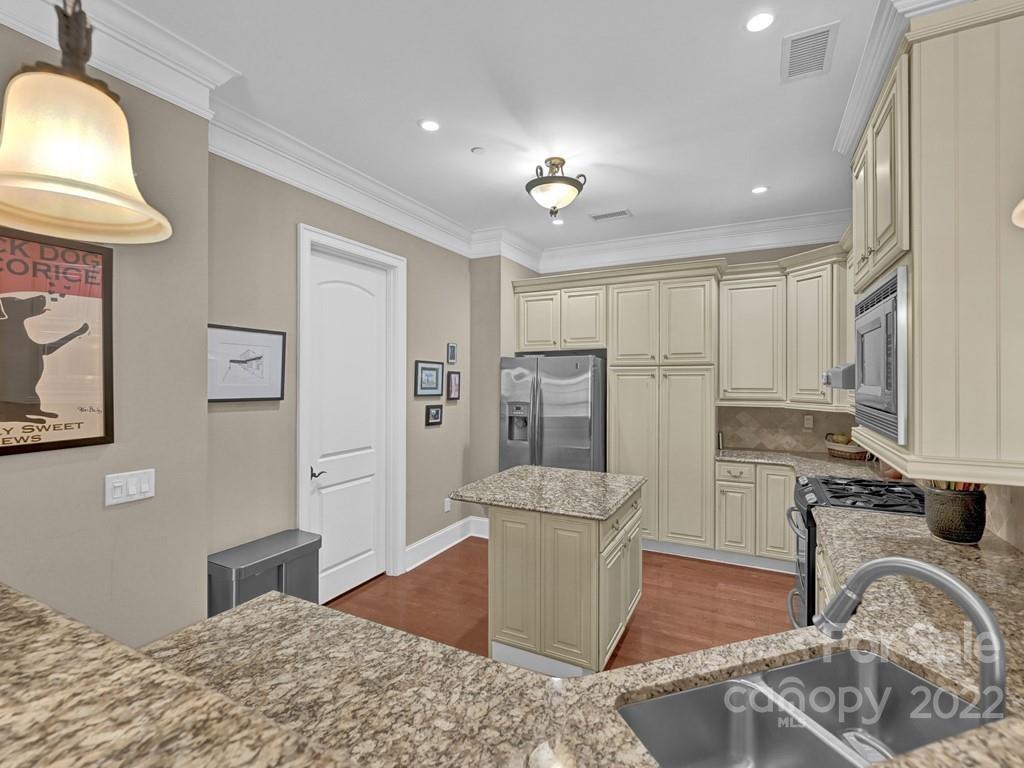 2823 Providence Road, Unit 125 Charlotte, NC 28211 - Photo 12 of 30 a kitchen with stainless steel appliances granite countertop a refrigerator sink and stove