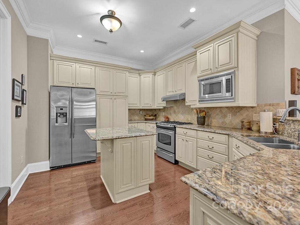 2823 Providence Road, Unit 125 Charlotte, NC 28211 - Photo 13 of 30 a kitchen with cabinets and wooden floor