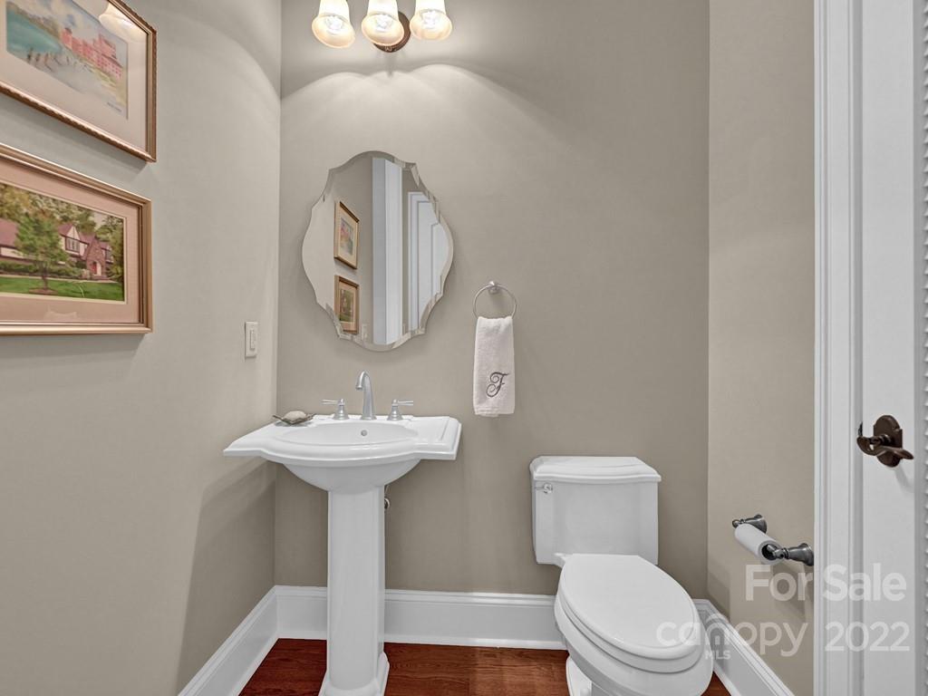 2823 Providence Road, Unit 125 Charlotte, NC 28211 - Photo 16 of 30 a bathroom with a toilet a sink and mirror