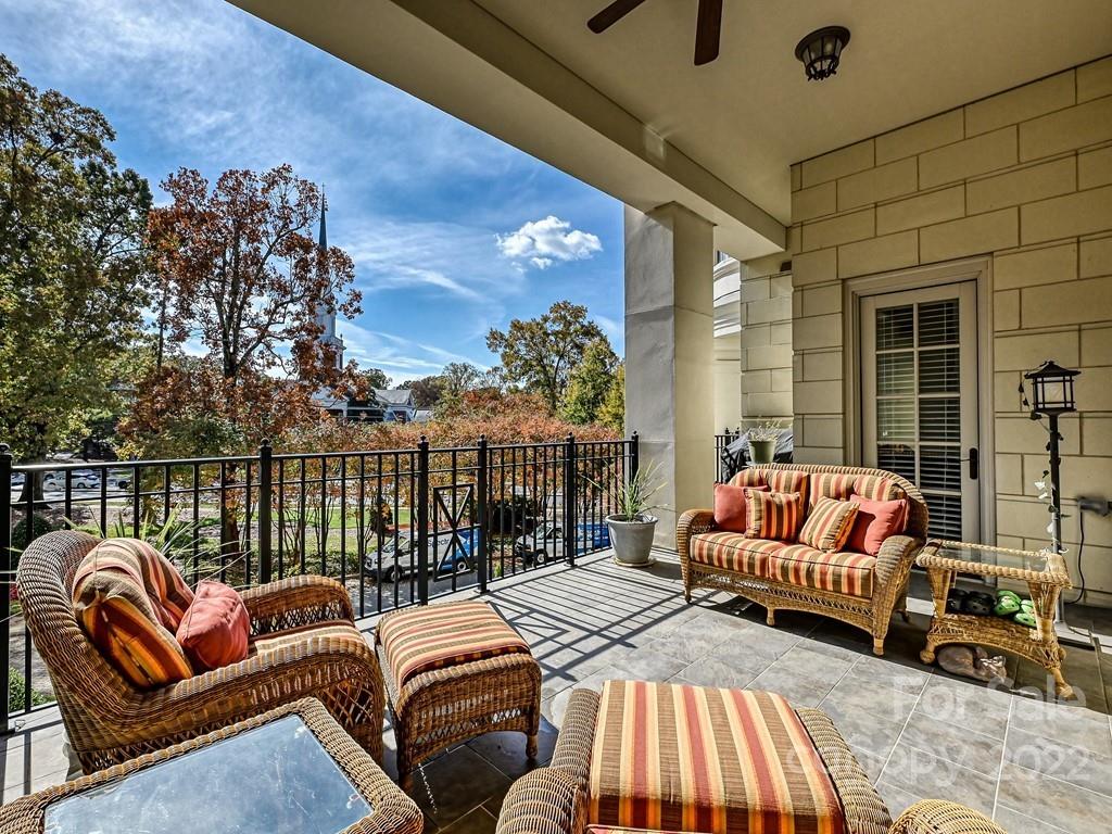 2823 Providence Road, Unit 125 Charlotte, NC 28211 - Photo 18 of 30 a balcony with furniture and a floor to ceiling window