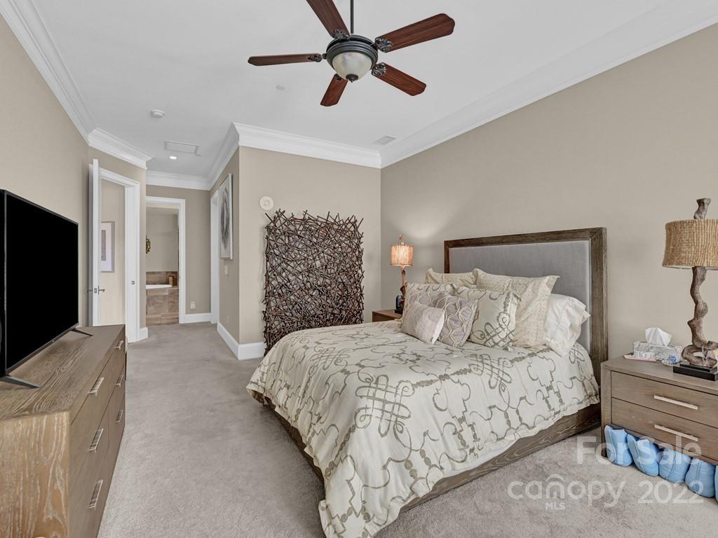 2823 Providence Road, Unit 125 Charlotte, NC 28211 - Photo 19 of 30 a bedroom with a bed and a flat screen tv