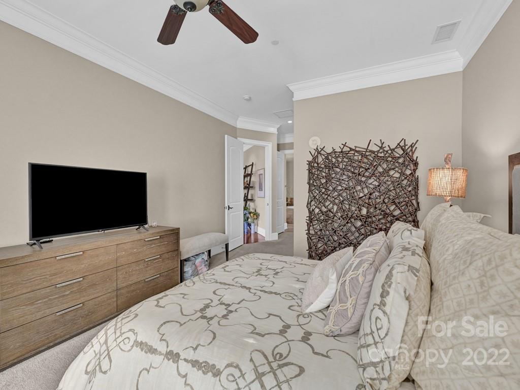 2823 Providence Road, Unit 125 Charlotte, NC 28211 - Photo 20 of 30 a bedroom with a bed and a flat screen tv