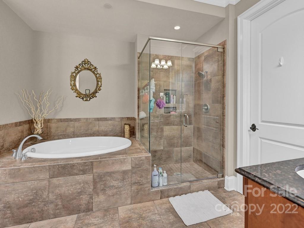 2823 Providence Road, Unit 125 Charlotte, NC 28211 - Photo 21 of 30 a bathroom with a granite countertop sink a mirror and a shower