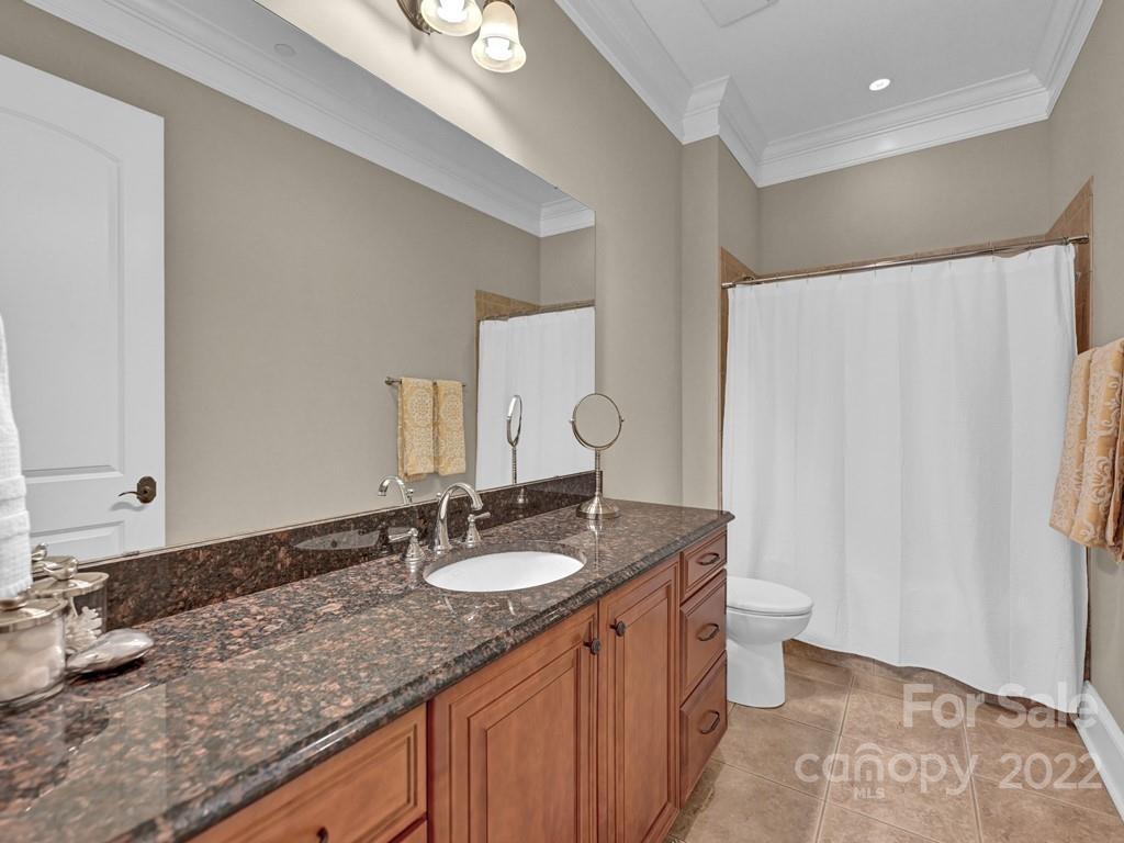 2823 Providence Road, Unit 125 Charlotte, NC 28211 - Photo 25 of 30 a bathroom with a granite countertop sink and a mirror