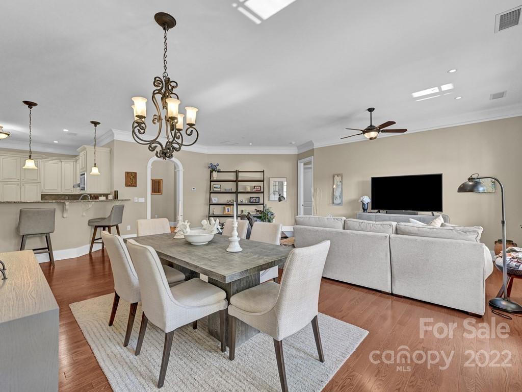 2823 Providence Road, Unit 125 Charlotte, NC 28211 - Photo 8 of 30 a view of a dining room with furniture wooden floor and chandelier