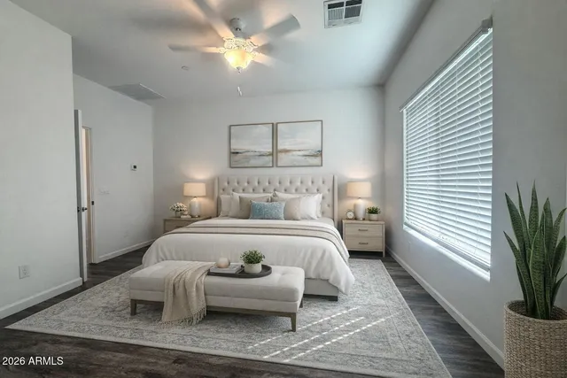 a bedroom with a large bed rug and a window