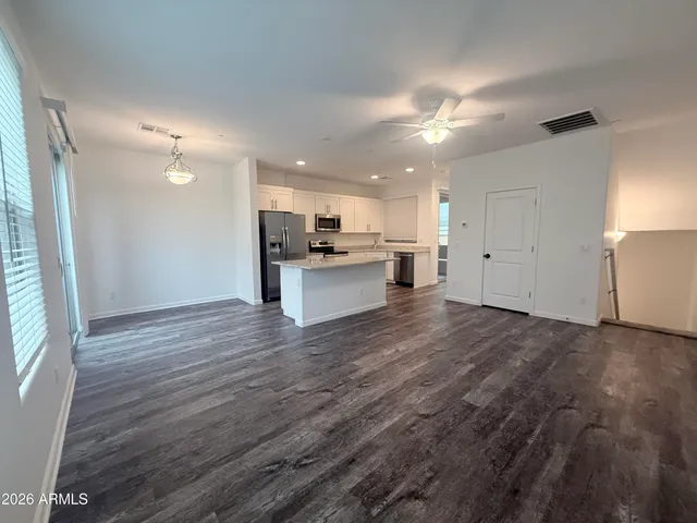 a view of a kitchen with a sink and a refrigerator