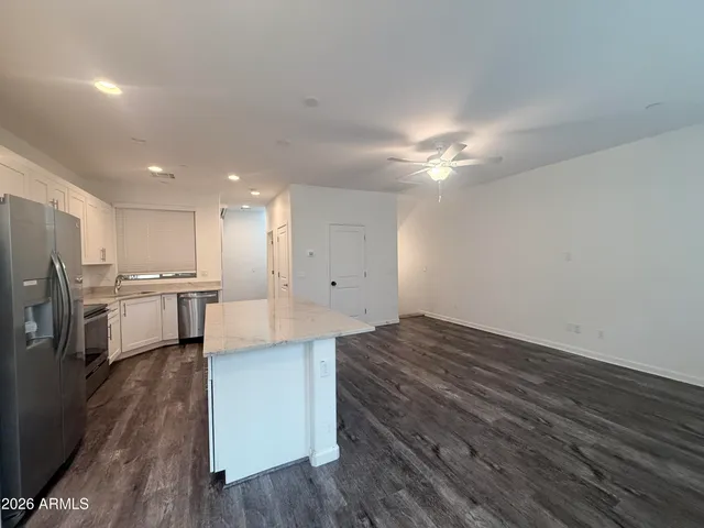 a view of kitchen with cabinets appliances and wooden floor