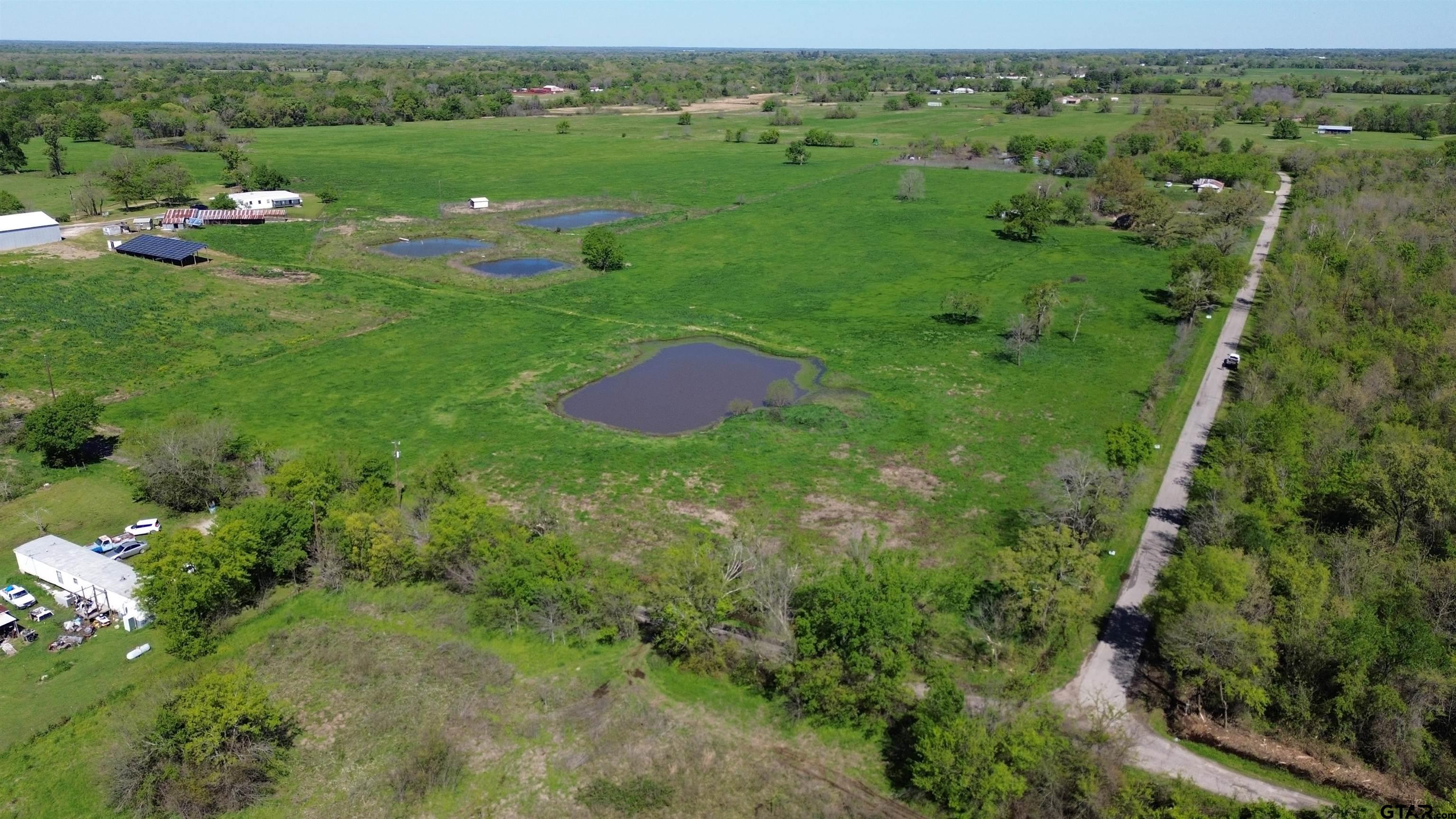 Lot 2 County Road 3410 Emory, TX 75440 - Photo 6 of 27 a view of a lush green outdoor space with a lake view