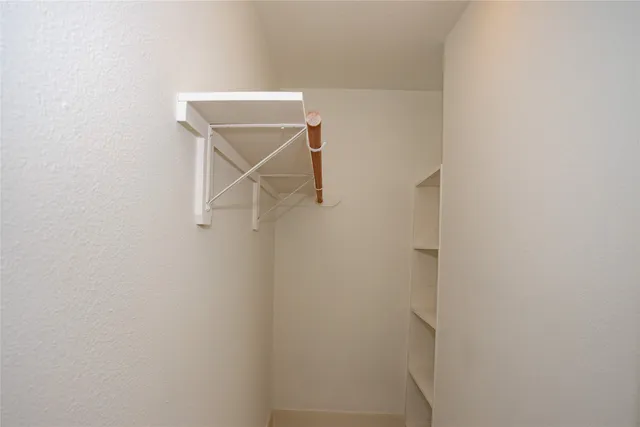 a utility room with a shower and a window