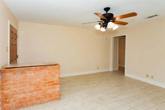 a view of a room with a ceiling fan