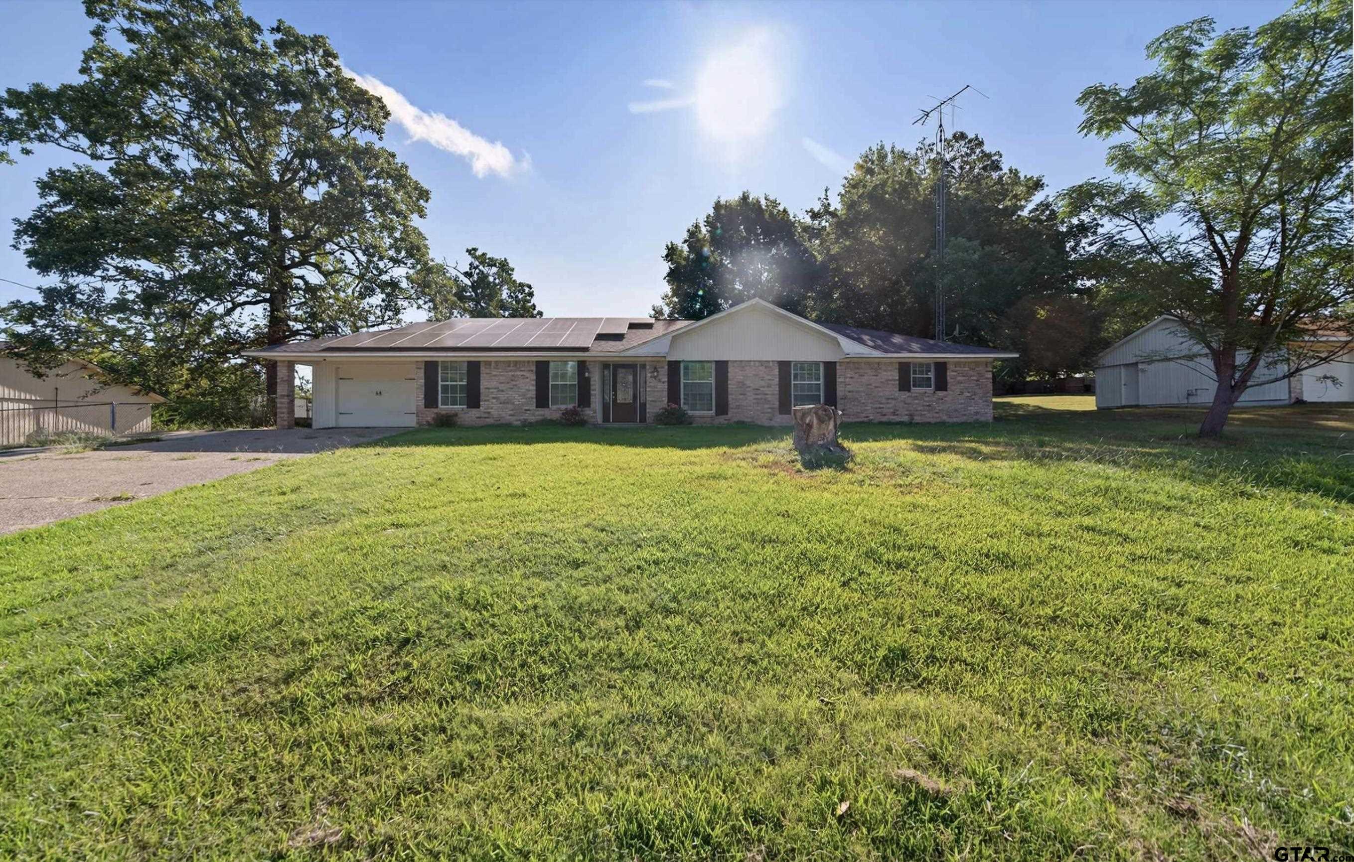 3408 Jackson Avenue Tyler, TX 75705 - Photo 5 of 45 a view of a house with a yard and large trees