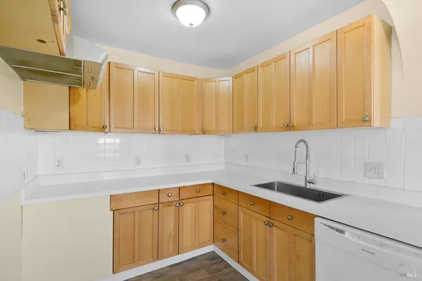 a kitchen with a sink cabinets and utility