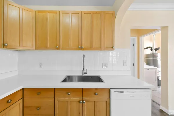 a kitchen with a sink cabinets and a window