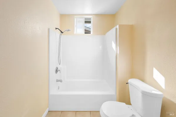 a bathroom with a toilet and a bathtub
