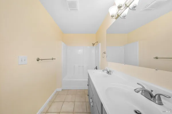 a bathroom with a sink a mirror and shower