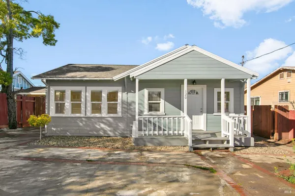 a front view of a house with outdoor seating
