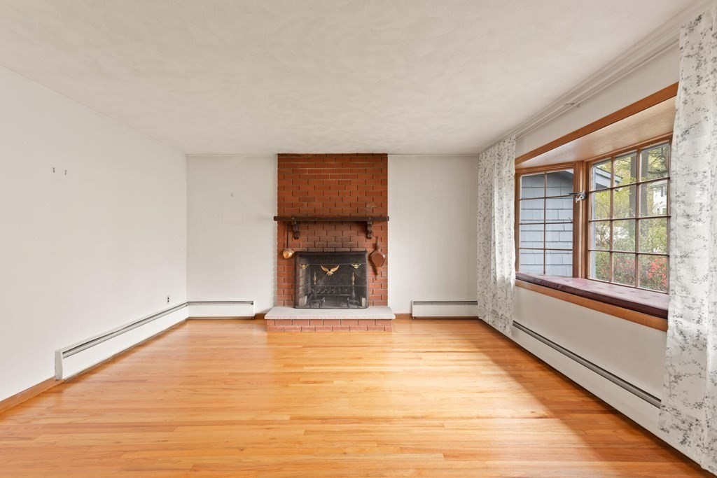 41 Ansie Road Chelmsford, MA 01824 - Photo 3 of 28 a view of an empty room with a window and wooden floor