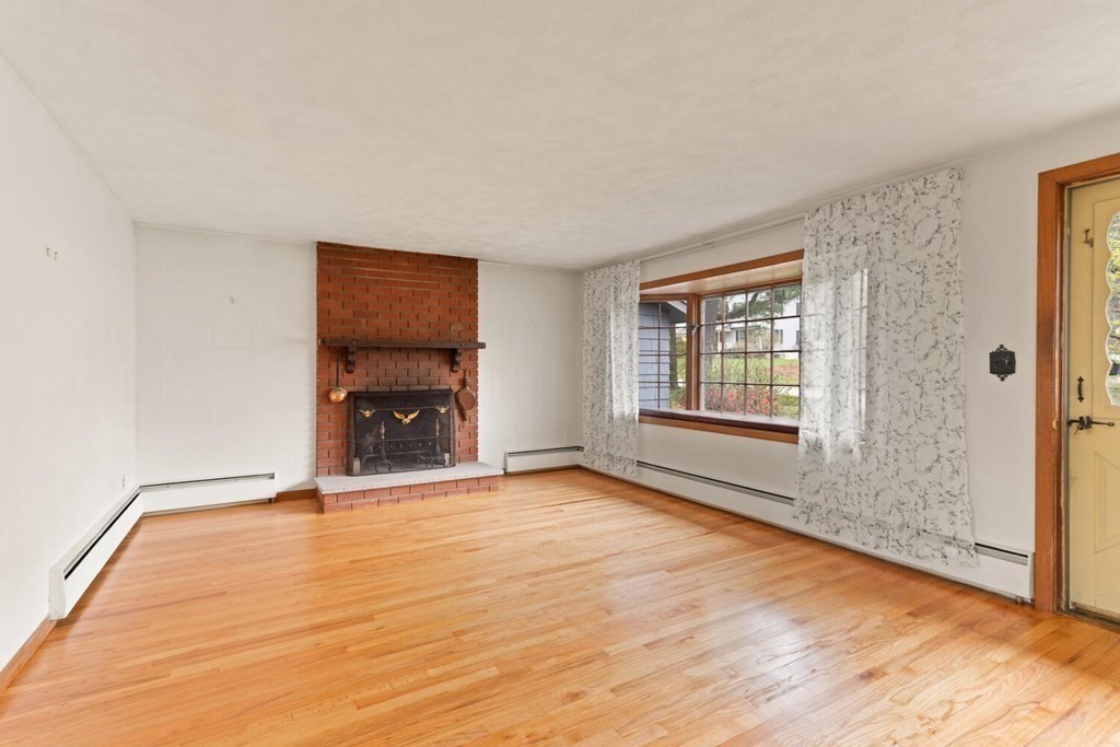 41 Ansie Road Chelmsford, MA 01824 - Photo 5 of 28 a view of an empty room with window and wooden floor